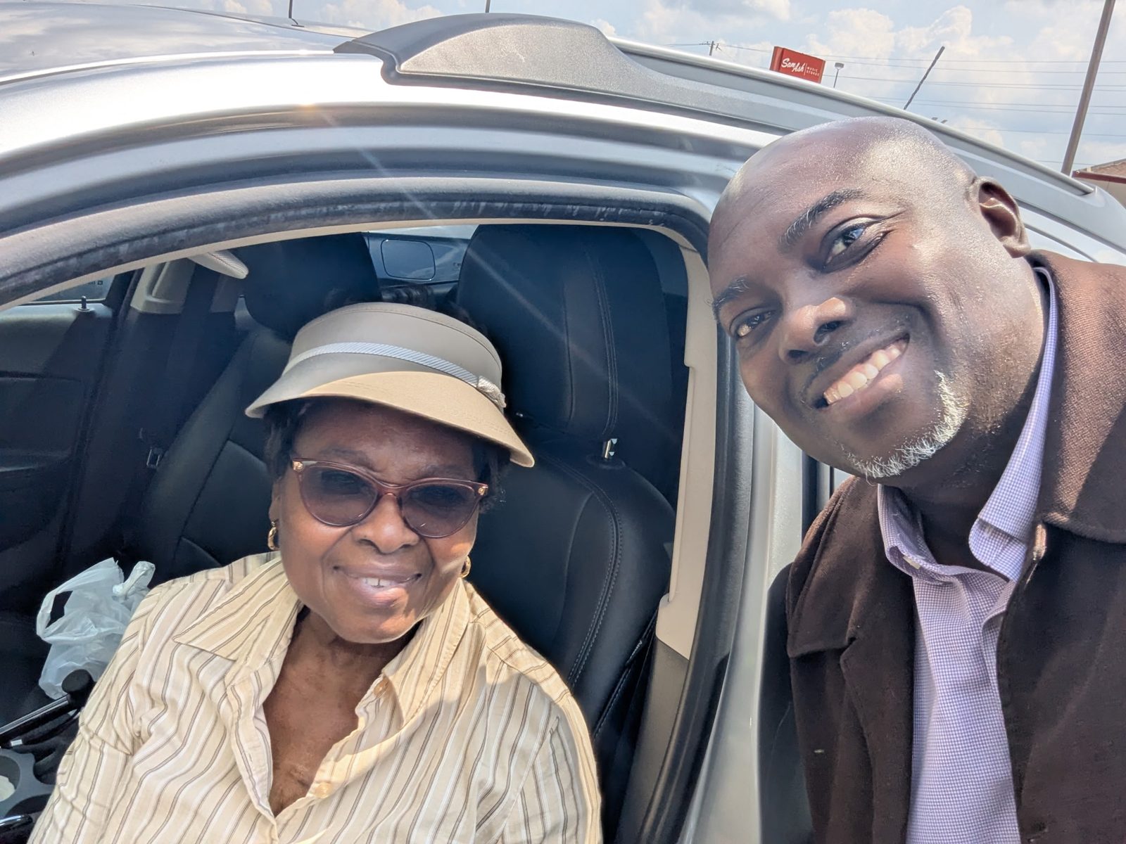 Emeka smiling in the car