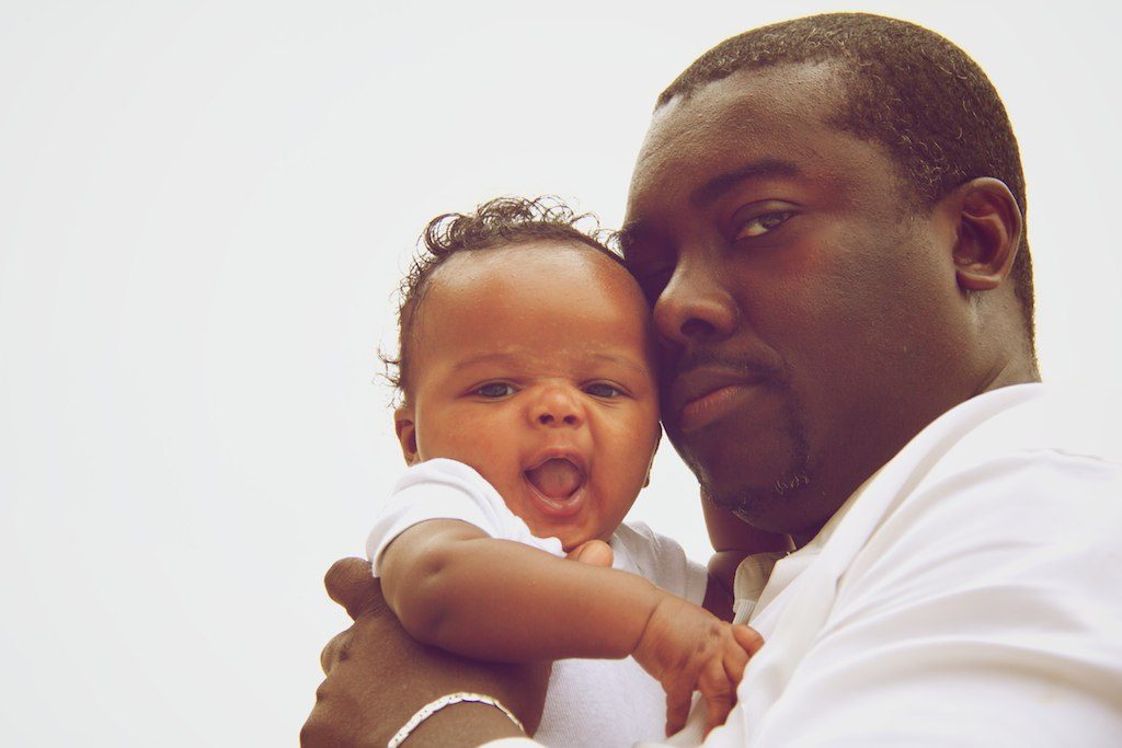 Emeka holding his baby